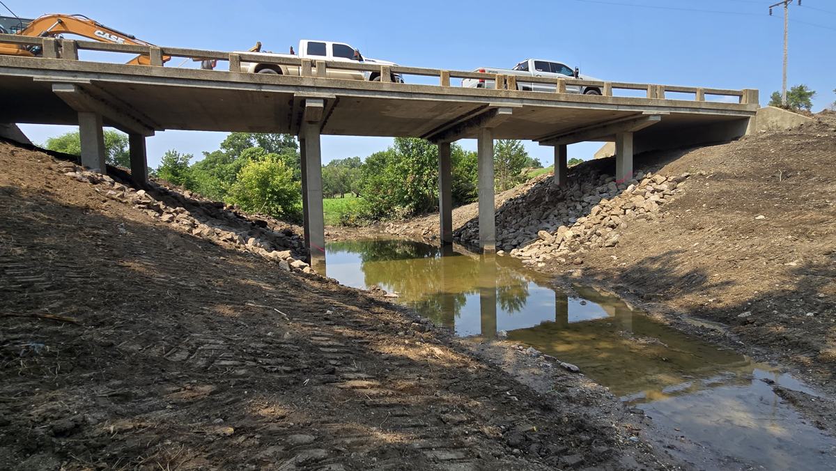 Riprap placed along the embankments under a concrete road bridge